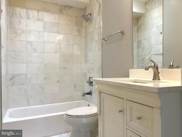 a bathroom with a sink a toilet and a bathtub