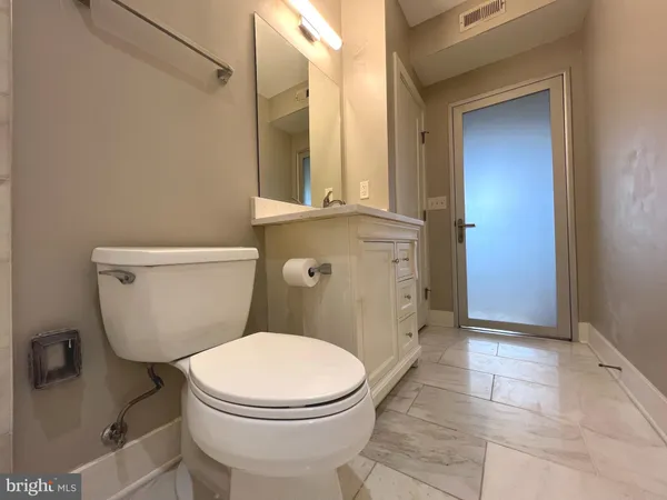 a white toilet sitting next to a bathroom sink
