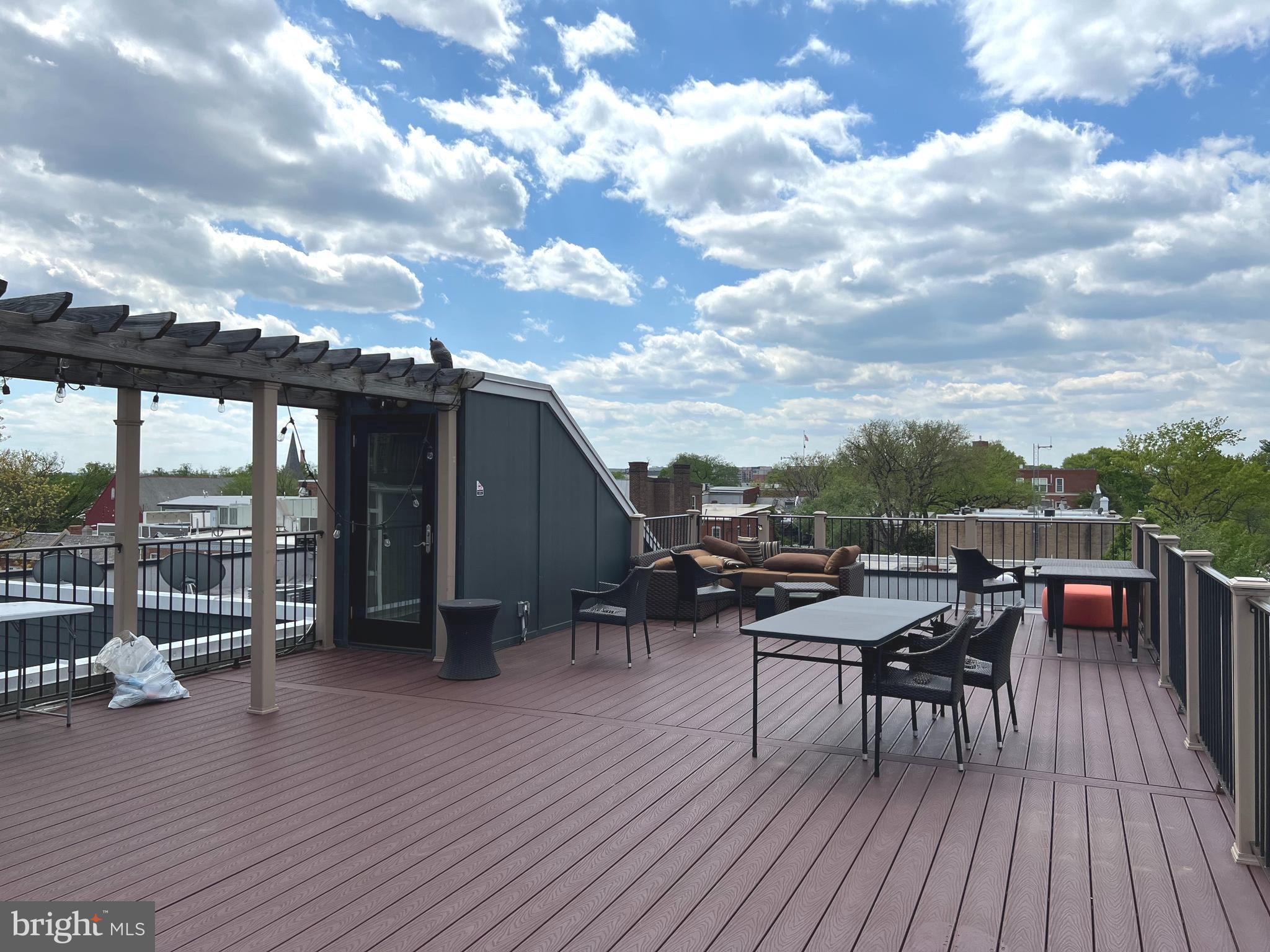 1209 G Street Southeast, Unit 8 Washington, DC 20003 - Photo 25 of 27 a view of roof deck with table and chairs a barbeque with wooden floor and fence