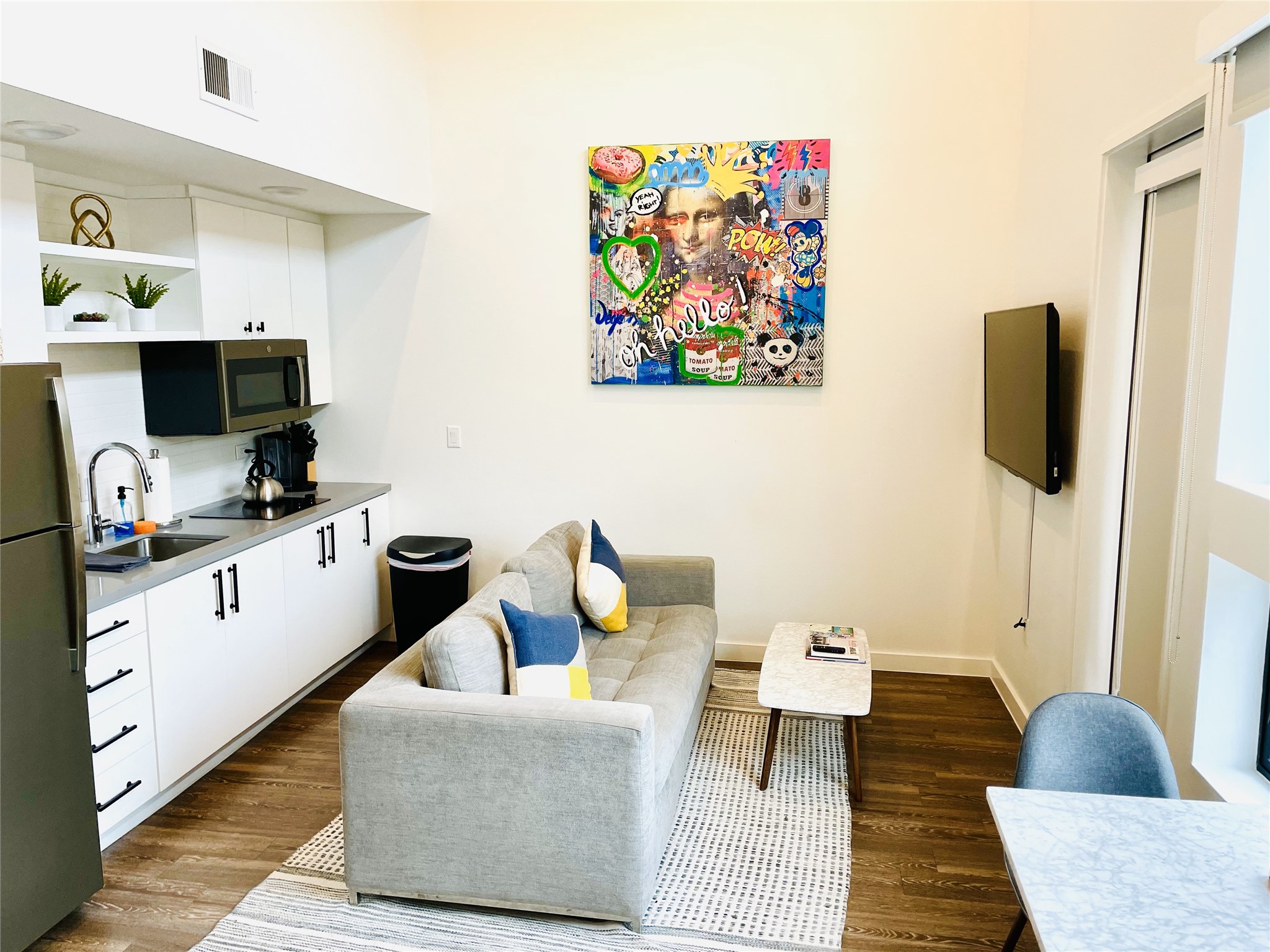 49 Navasota Street, Unit 201 Austin, TX 78702 - Photo 1 of 13 a living room with furniture and a flat screen tv
