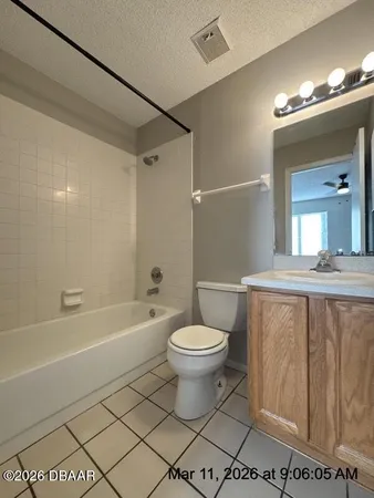 a bathroom with a toilet a sink a mirror and bathtub