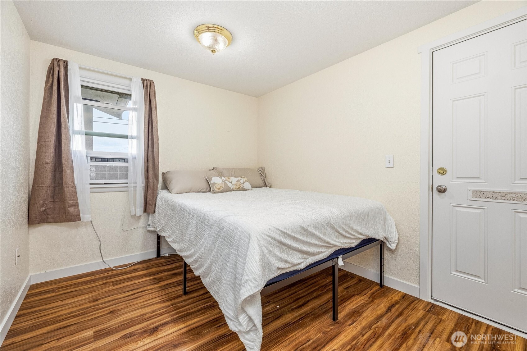 113 South Gardner Road Burlington, WA 98233 - Photo 37 of 40 a bedroom with a bed and wooden floor