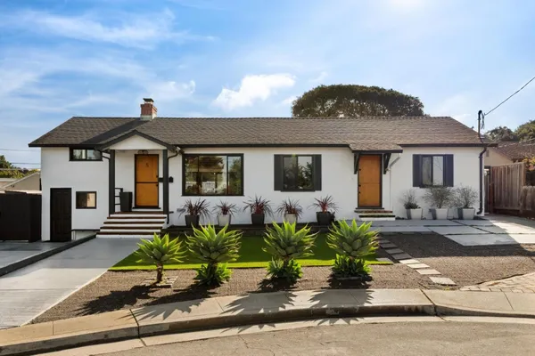a front view of a house with a garden