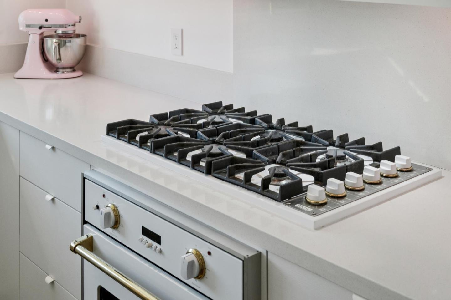 5 Bush Street Monterey, CA 93940 - Photo 17 of 48 a close view of a stove a microwave and cabinets