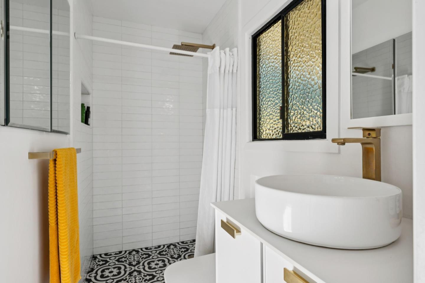 5 Bush Street Monterey, CA 93940 - Photo 32 of 48 a bathroom with a sink and a mirror