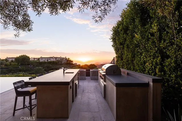 a large kitchen with kitchen island a large window a sink and stainless steel appliances