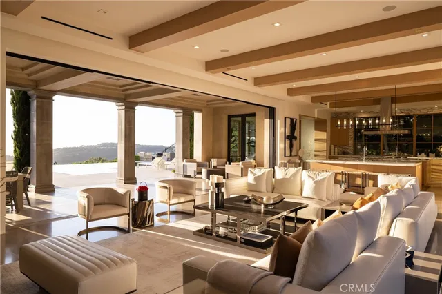 a dining room with furniture a potted plant and a large window