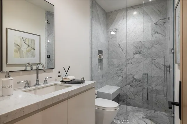 a kitchen with stainless steel appliances a sink a stove and a refrigerator