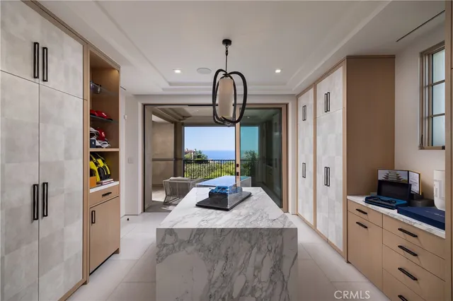 a view of a brick house with plants and large trees
