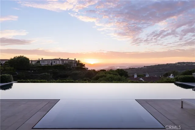 a kitchen with kitchen island a large window a sink and cabinets
