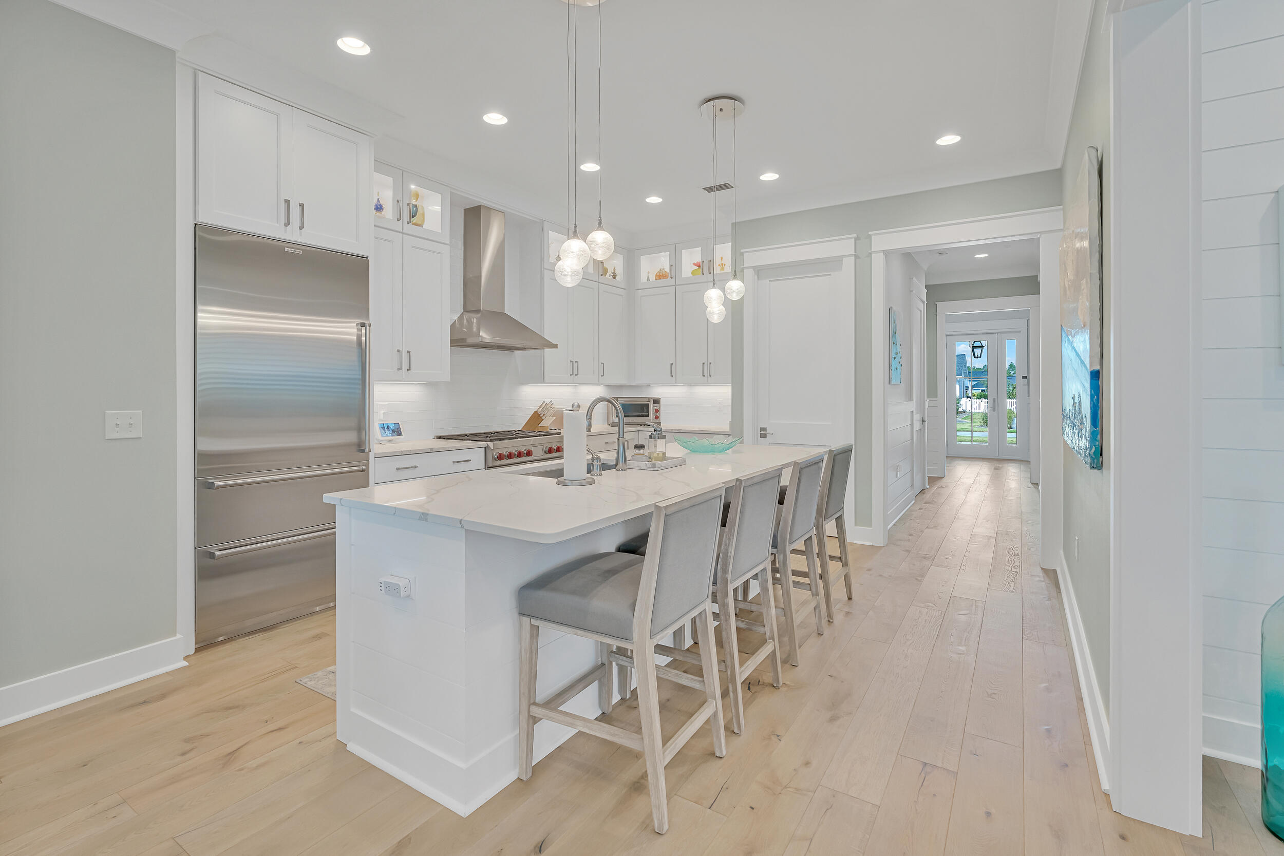 70 Sidecamp Road, Unit LOT 92 Watersound, FL 32461 - Photo 12 of 58 a kitchen with kitchen island granite countertop a sink and refrigerator