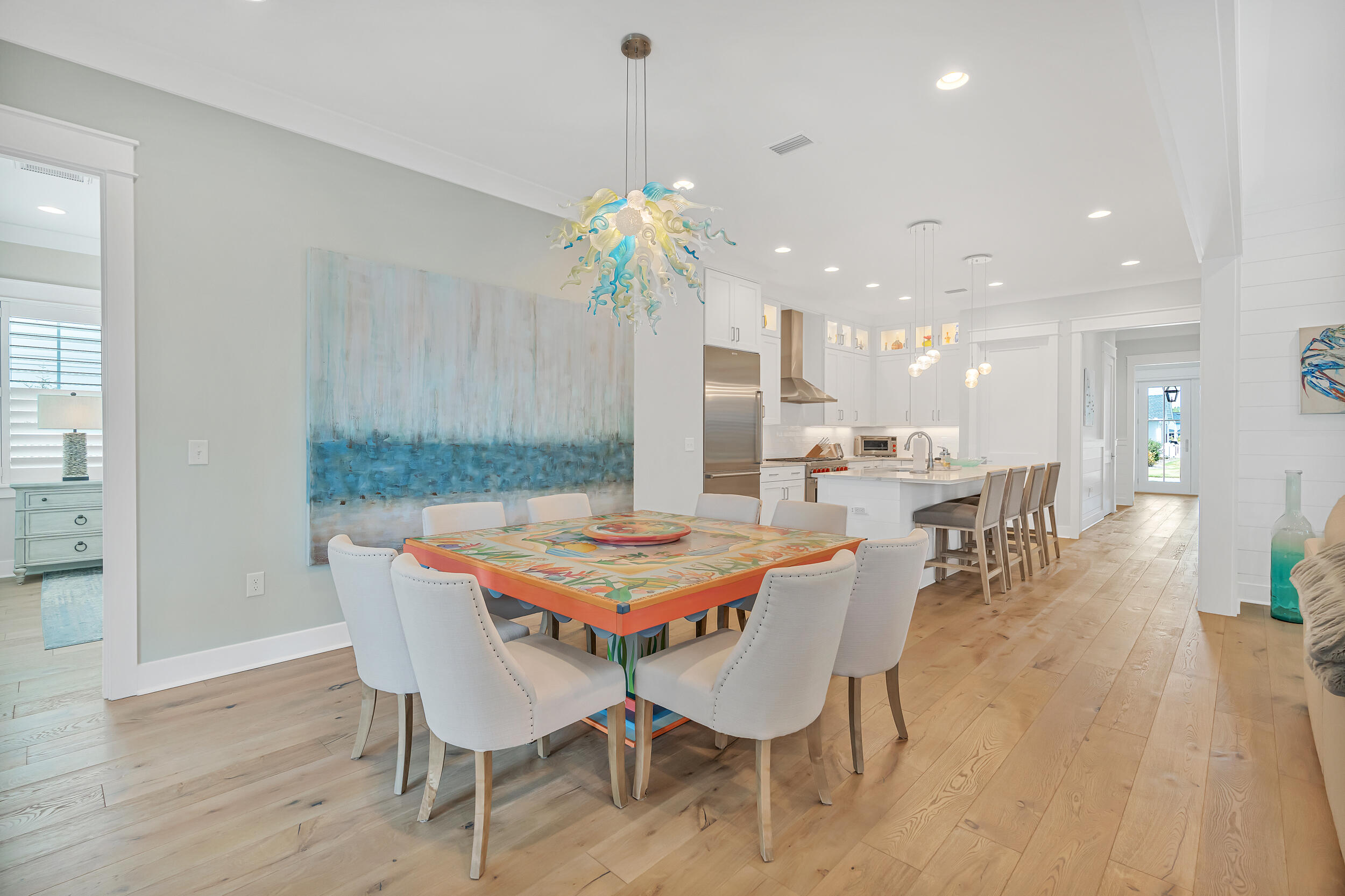 70 Sidecamp Road, Unit LOT 92 Watersound, FL 32461 - Photo 15 of 58 a dining room with furniture a chandelier and wooden floor
