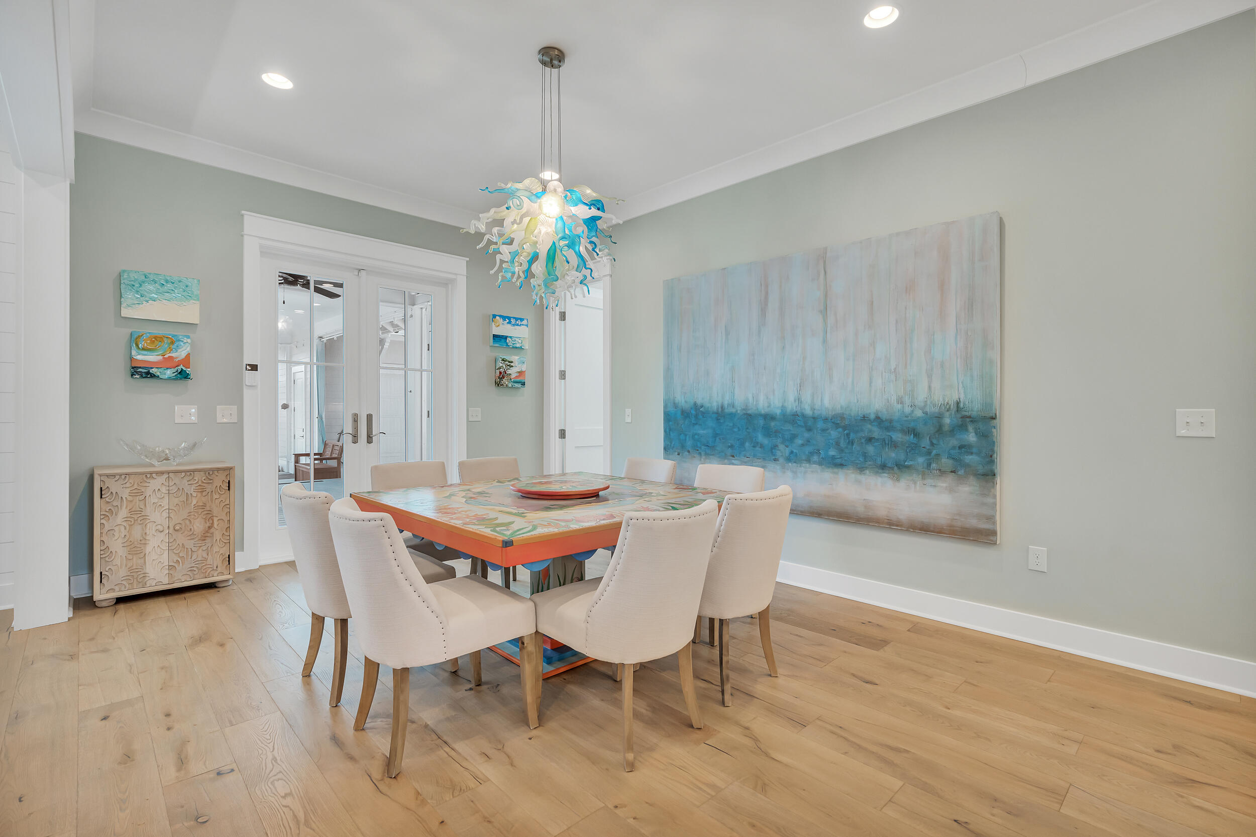 70 Sidecamp Road, Unit LOT 92 Watersound, FL 32461 - Photo 17 of 58 a view of a dining room with furniture and chandelier
