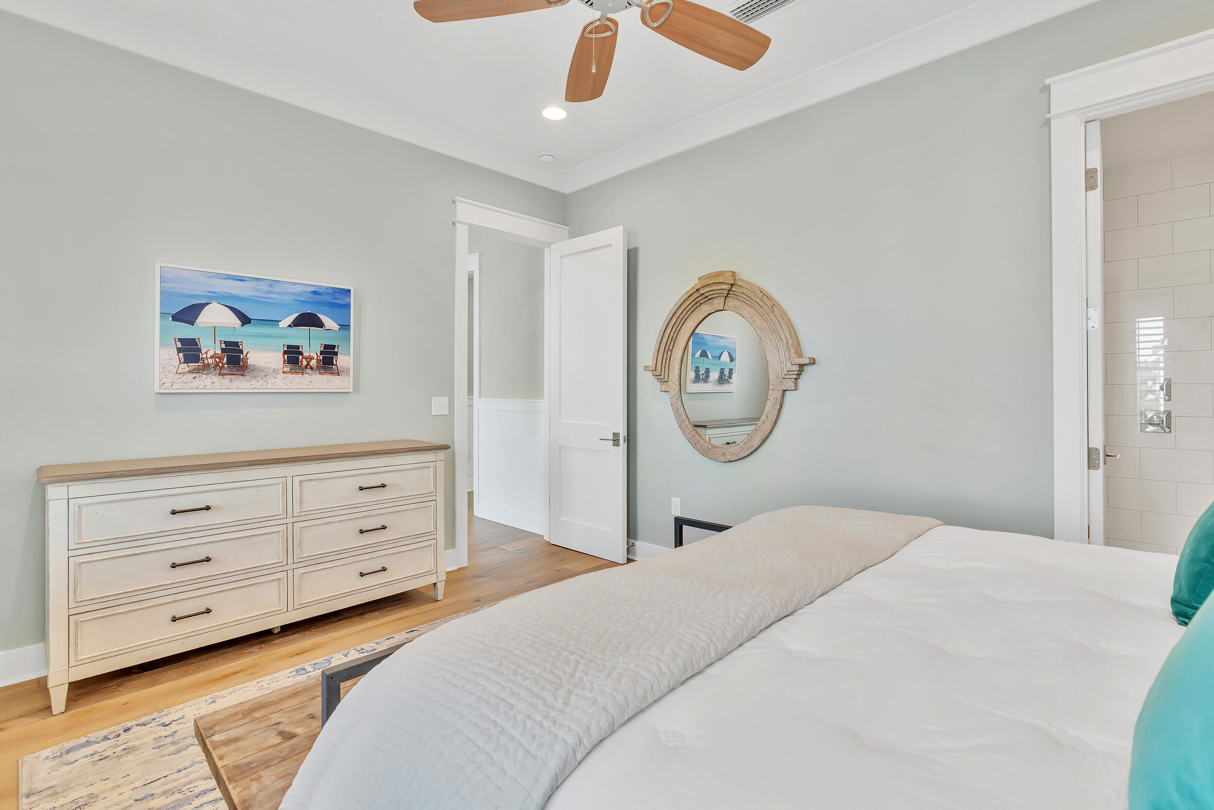 70 Sidecamp Road, Unit LOT 92 Watersound, FL 32461 - Photo 23 of 58 a bedroom with a bed a clock and a large mirror