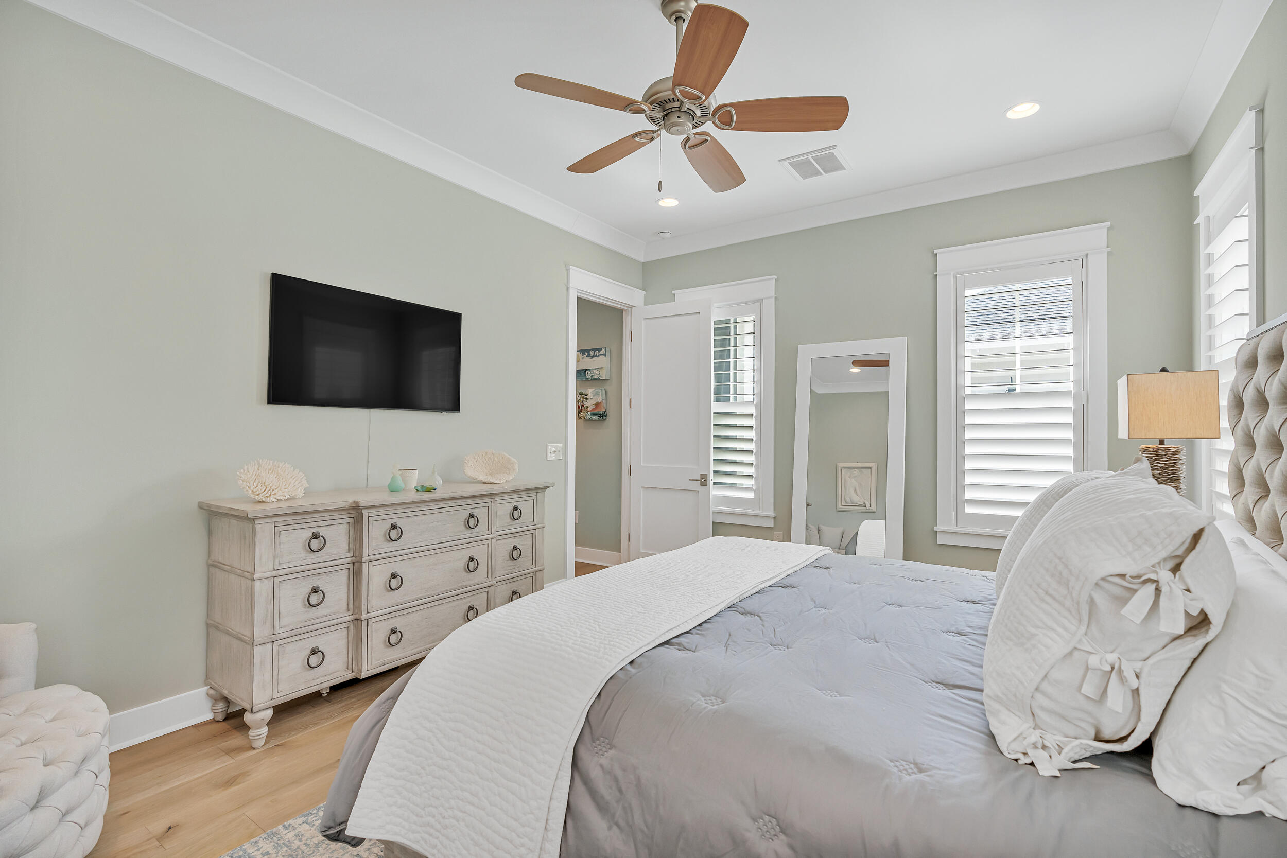 70 Sidecamp Road, Unit LOT 92 Watersound, FL 32461 - Photo 27 of 58 a bedroom with a large bed and a flat tv screen on dresser