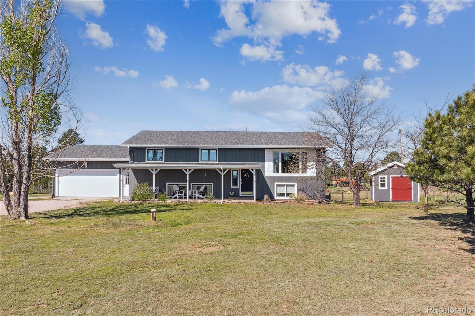 a view of a house with garden and trees