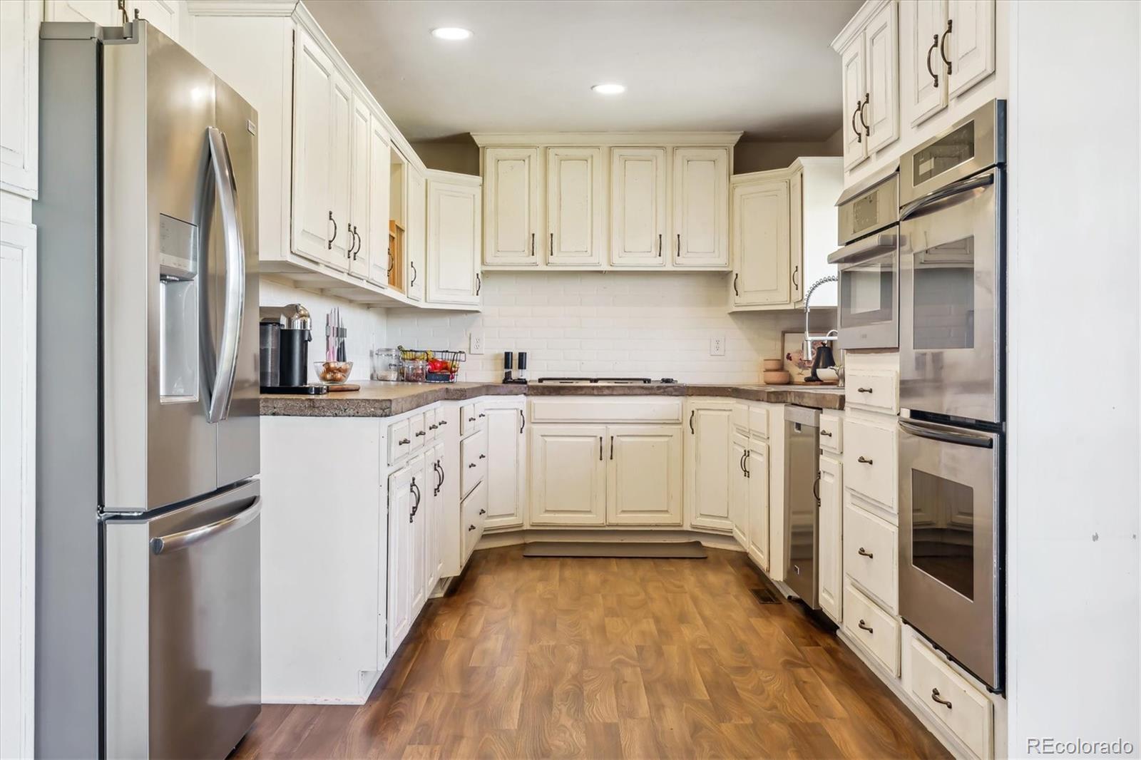 36901 View Ridge Drive Elizabeth, CO 80107 - Photo 11 of 31 a kitchen with white cabinets and white appliances