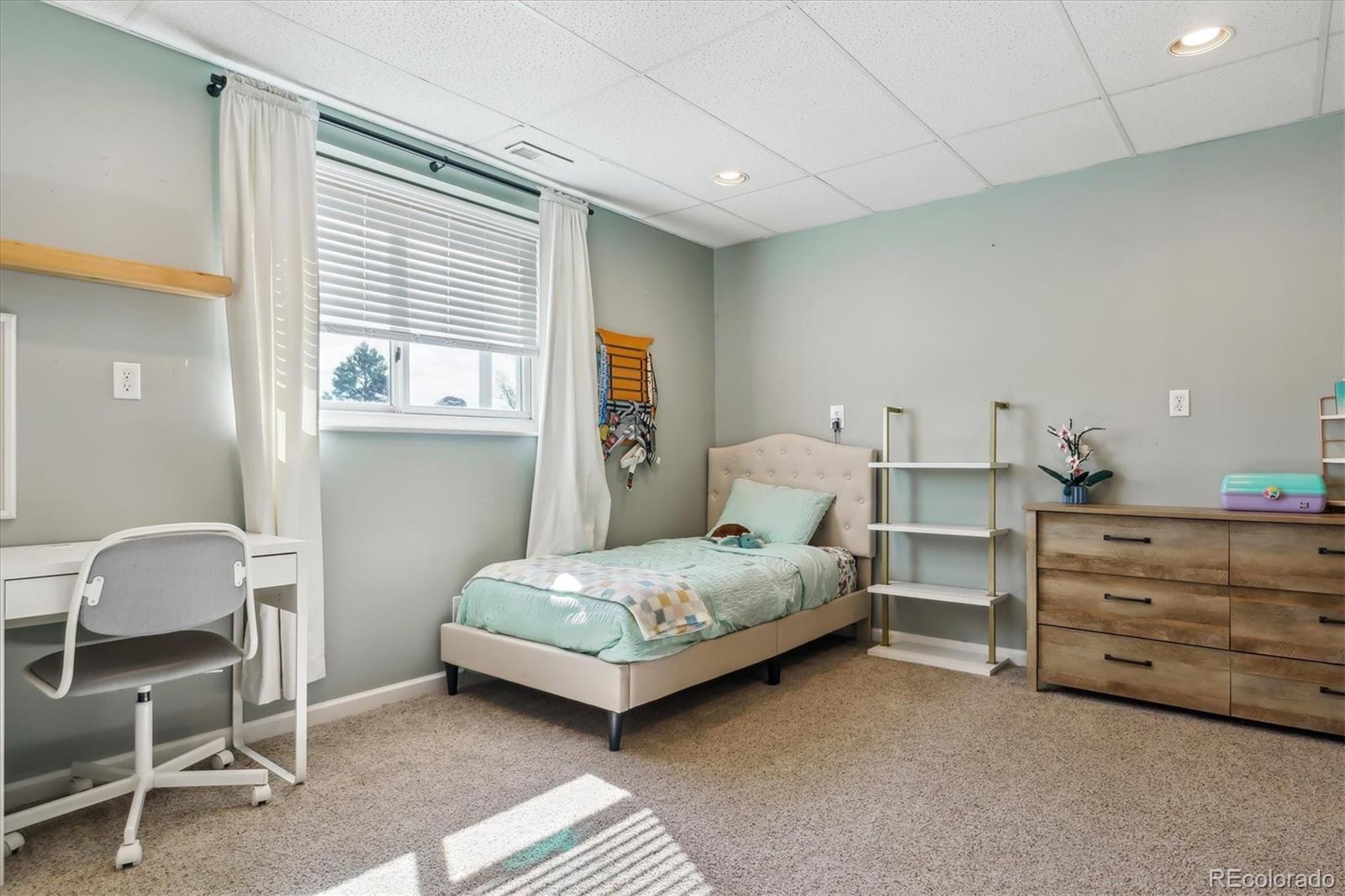 36901 View Ridge Drive Elizabeth, CO 80107 - Photo 16 of 31 a bedroom with a bed and a chair