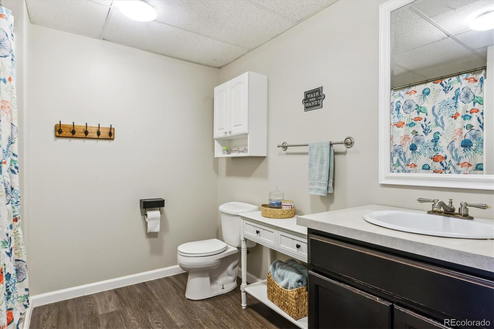 36901 View Ridge Drive Elizabeth, CO 80107 - Photo 17 of 31 a bathroom with a sink a toilet and a shower curtain