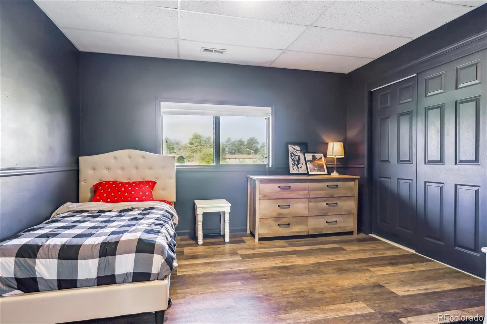 36901 View Ridge Drive Elizabeth, CO 80107 - Photo 18 of 31 a bedroom with a bed and wooden floor