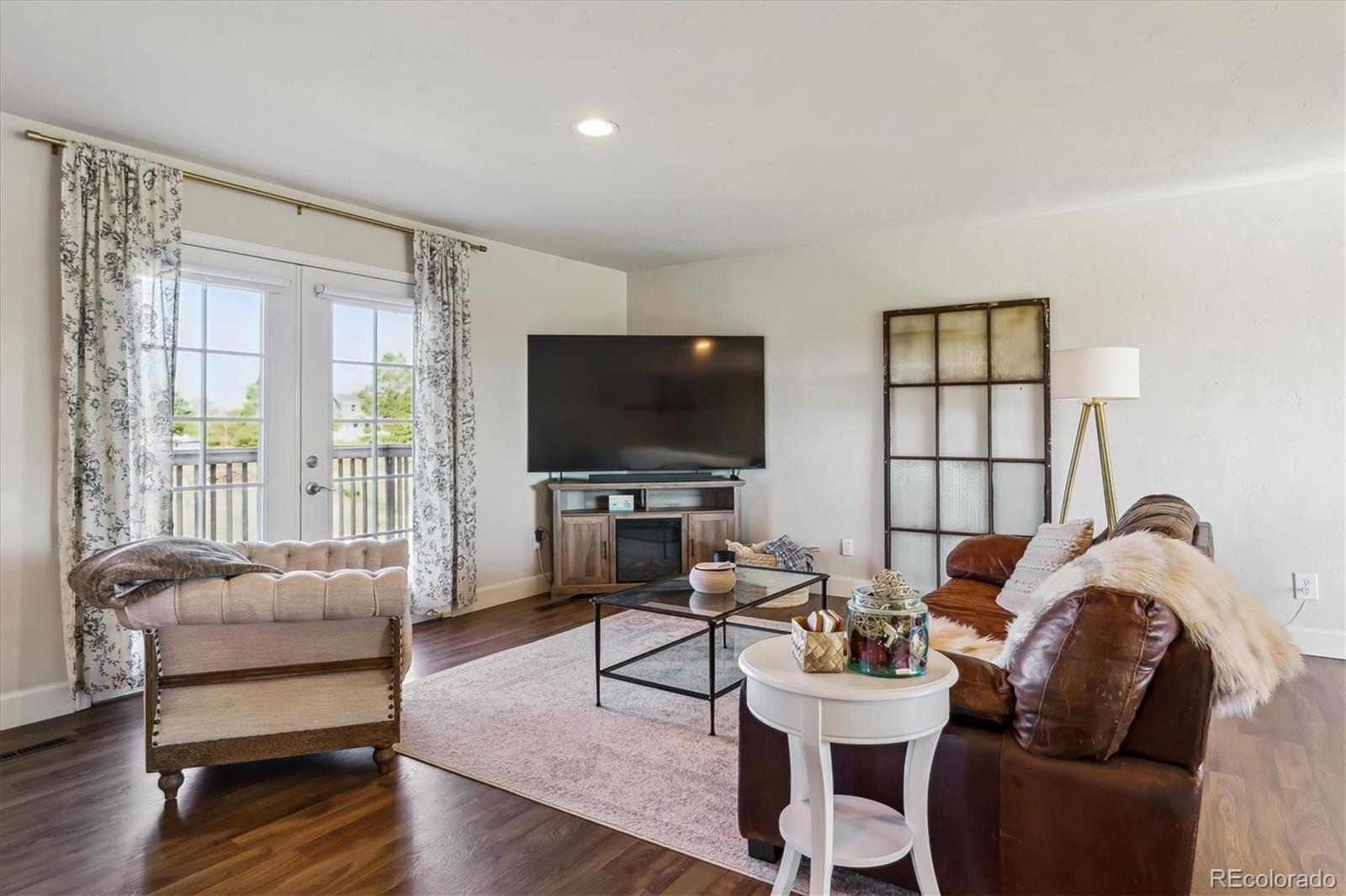 36901 View Ridge Drive Elizabeth, CO 80107 - Photo 5 of 31 a living room with furniture a flat screen tv and a large window