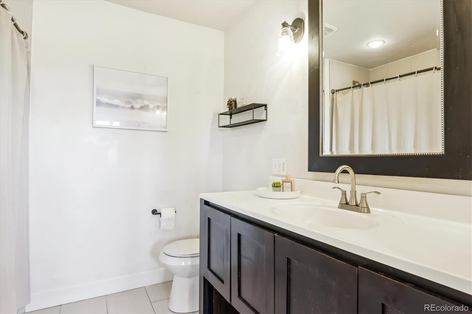 36901 View Ridge Drive Elizabeth, CO 80107 - Photo 8 of 31 a bathroom with a toilet a sink and mirror