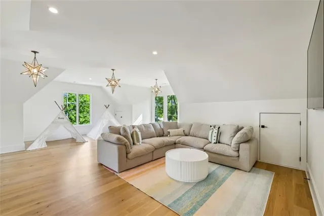 a living room with furniture a fireplace and wall paintings