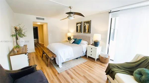 a bedroom with a bed couch and a window