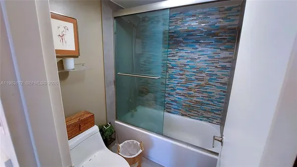 a bathroom with a shower and a toilet