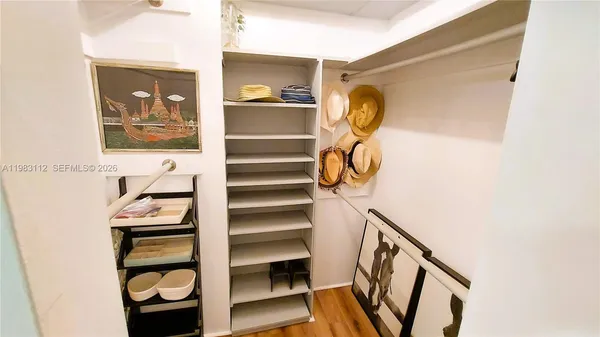 a view of a hallway with entryway and hall with wooden floor
