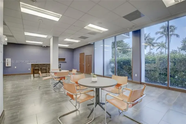 a living room with furniture a table and chairs