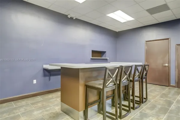 a view of an chairs and table in a room