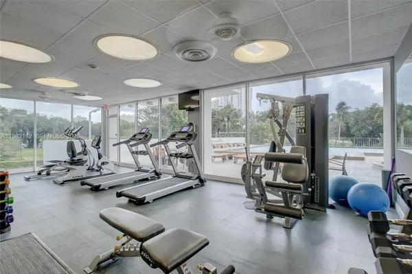 a view of a room with gym equipment and floor to ceiling window