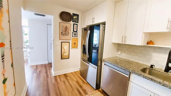 a kitchen with a refrigerator and a sink