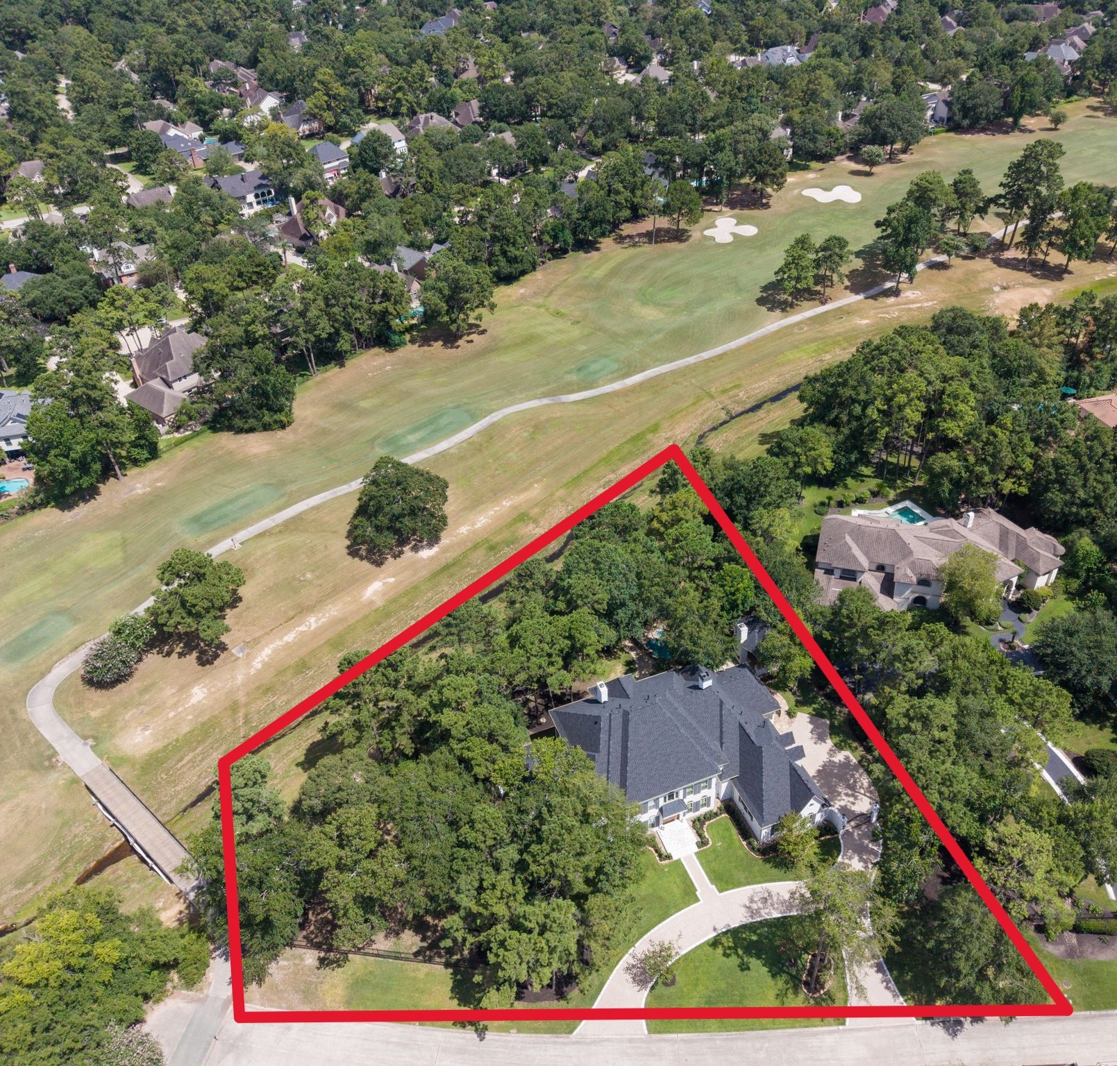 31 Hollymead Drive Spring, TX 77381 - Photo 4 of 50 This aerial photo showcases this beautiful home nestled in a lush, tree-filled neighborhood, backing to the King golf course. Located at the end of a cul-de-sac street. The property features a spacious wooded yard. Only minutes from the Woodlands Country Club.