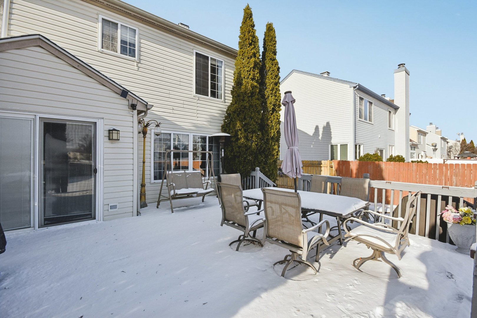 521 Ivory Lane Bartlett, IL 60103 - Photo 21 of 28 a view of a patio with a table and chairs and floor to ceiling window