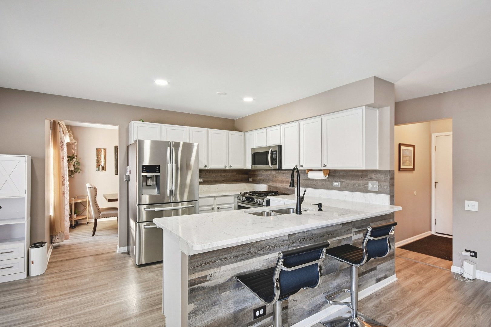 521 Ivory Lane Bartlett, IL 60103 - Photo 6 of 28 a kitchen with stainless steel appliances kitchen island granite countertop a refrigerator and a stove top oven