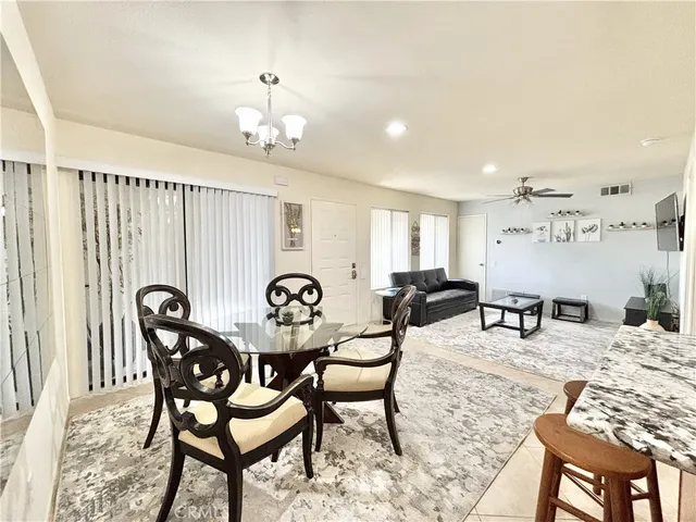 a view of a dining room with furniture and chandelier