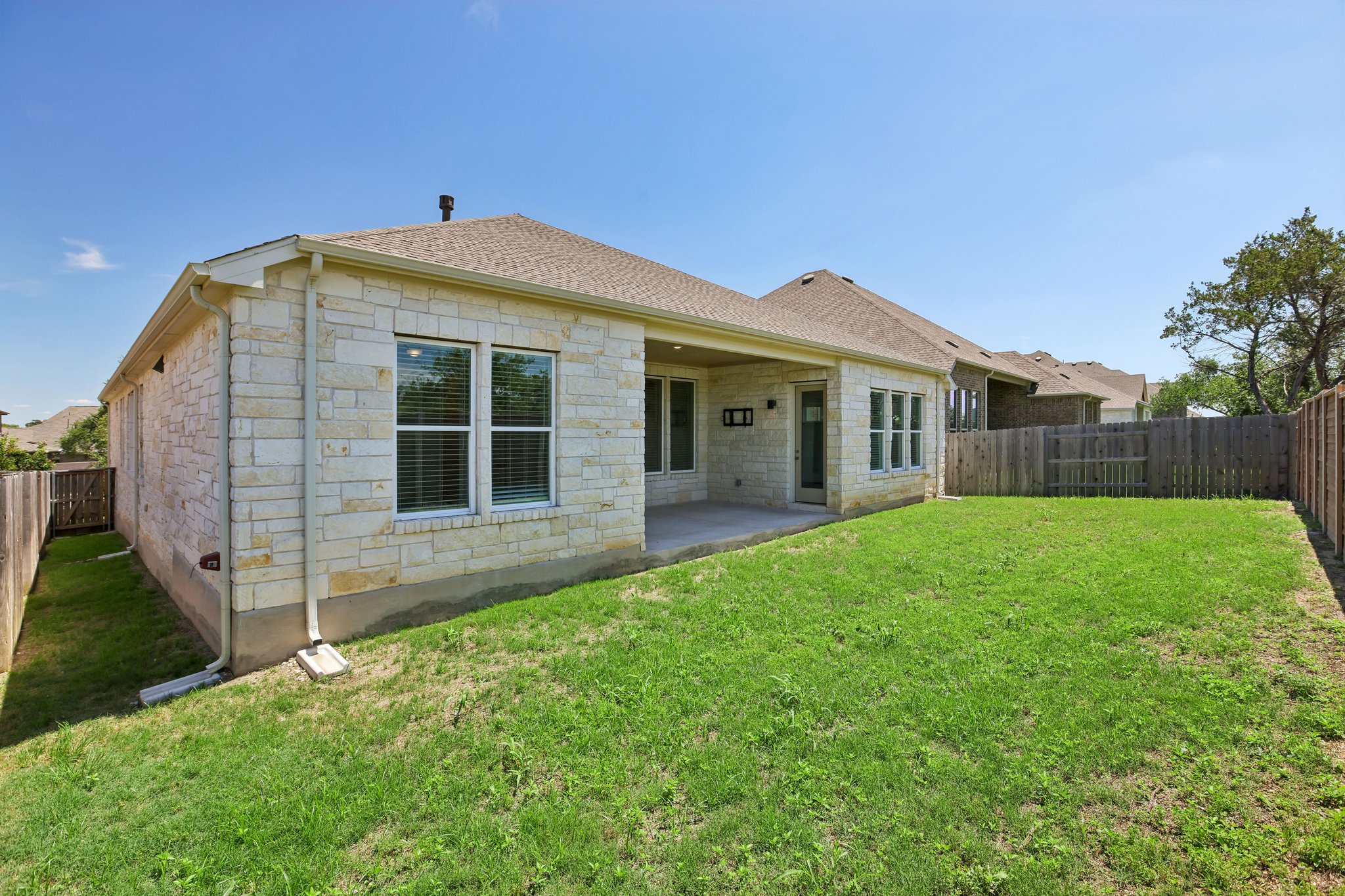 317 Independence Drive Kyle, TX 78640 - Photo 36 of 40 a view of an house with backyard space and garden