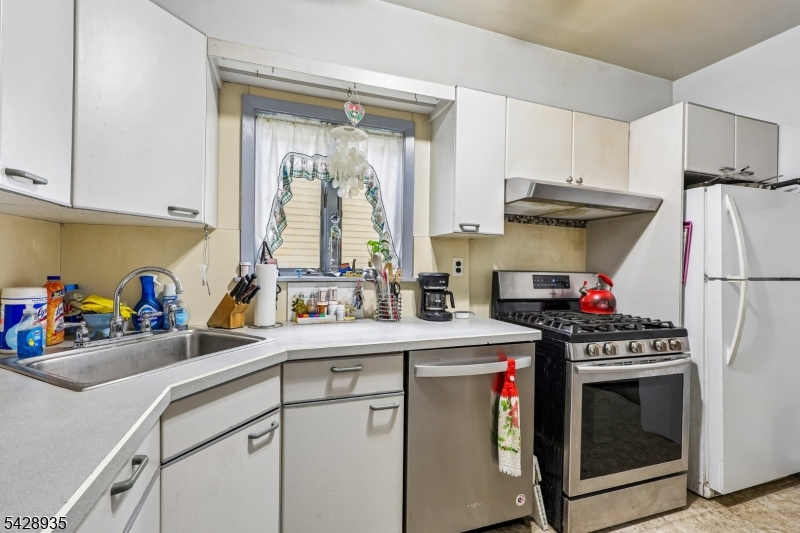 50 Preston Street Ridgefield Park, NJ 07660 - Photo 15 of 41 a kitchen with a sink cabinets and stainless steel appliances