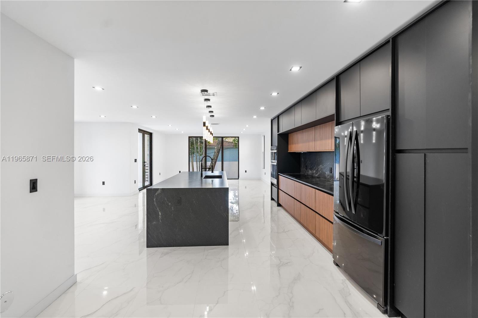 1644 Northwest 8th Terrace Miami, FL 33125 - Photo 18 of 60 a living room with stainless steel appliances kitchen island granite countertop a refrigerator and a stove top oven