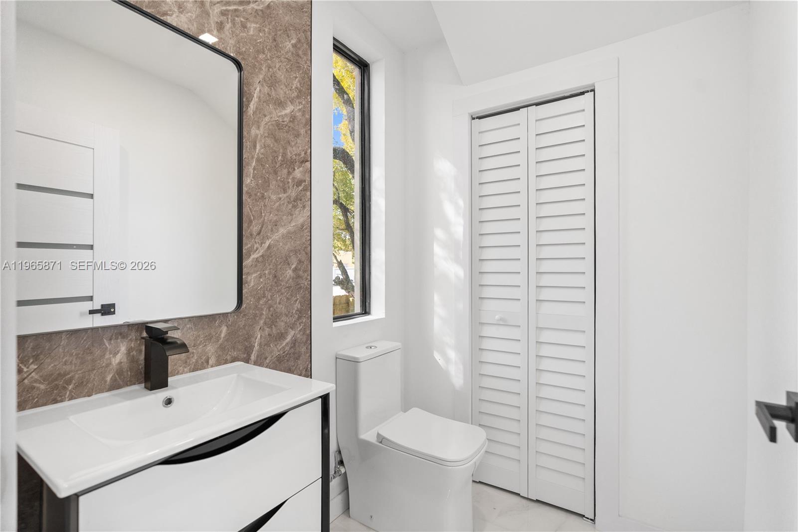 1644 Northwest 8th Terrace Miami, FL 33125 - Photo 20 of 60 a bathroom with a sink toilet and window