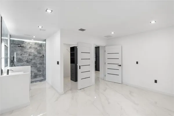 a bathroom with a sink a toilet a mirror and shower