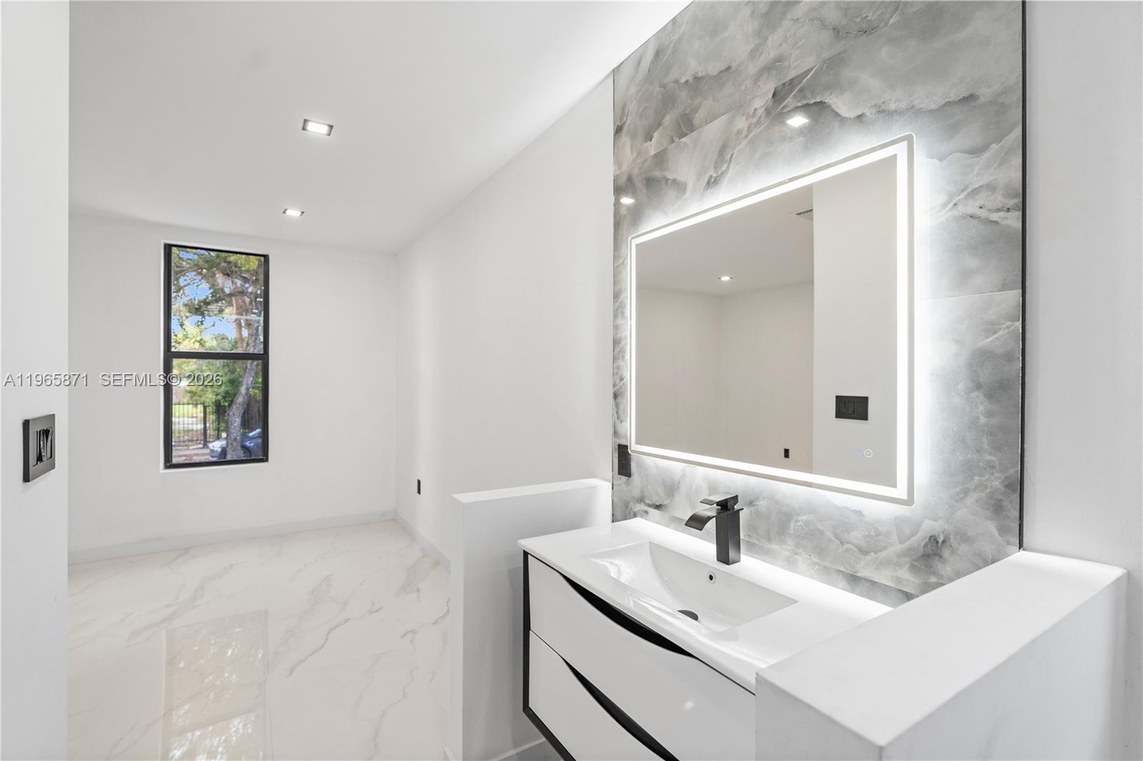 1644 Northwest 8th Terrace Miami, FL 33125 - Photo 24 of 60 a bathroom with a sink and a mirror