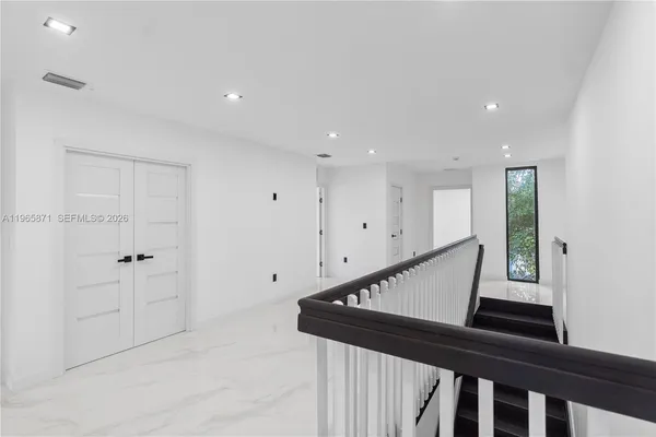 a view of a room with a window and a hallway