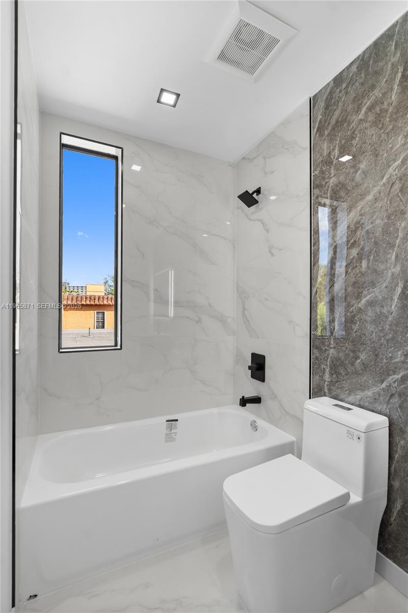 1644 Northwest 8th Terrace Miami, FL 33125 - Photo 36 of 60 a bathroom with a bathtub shower sink vanity and a toilet