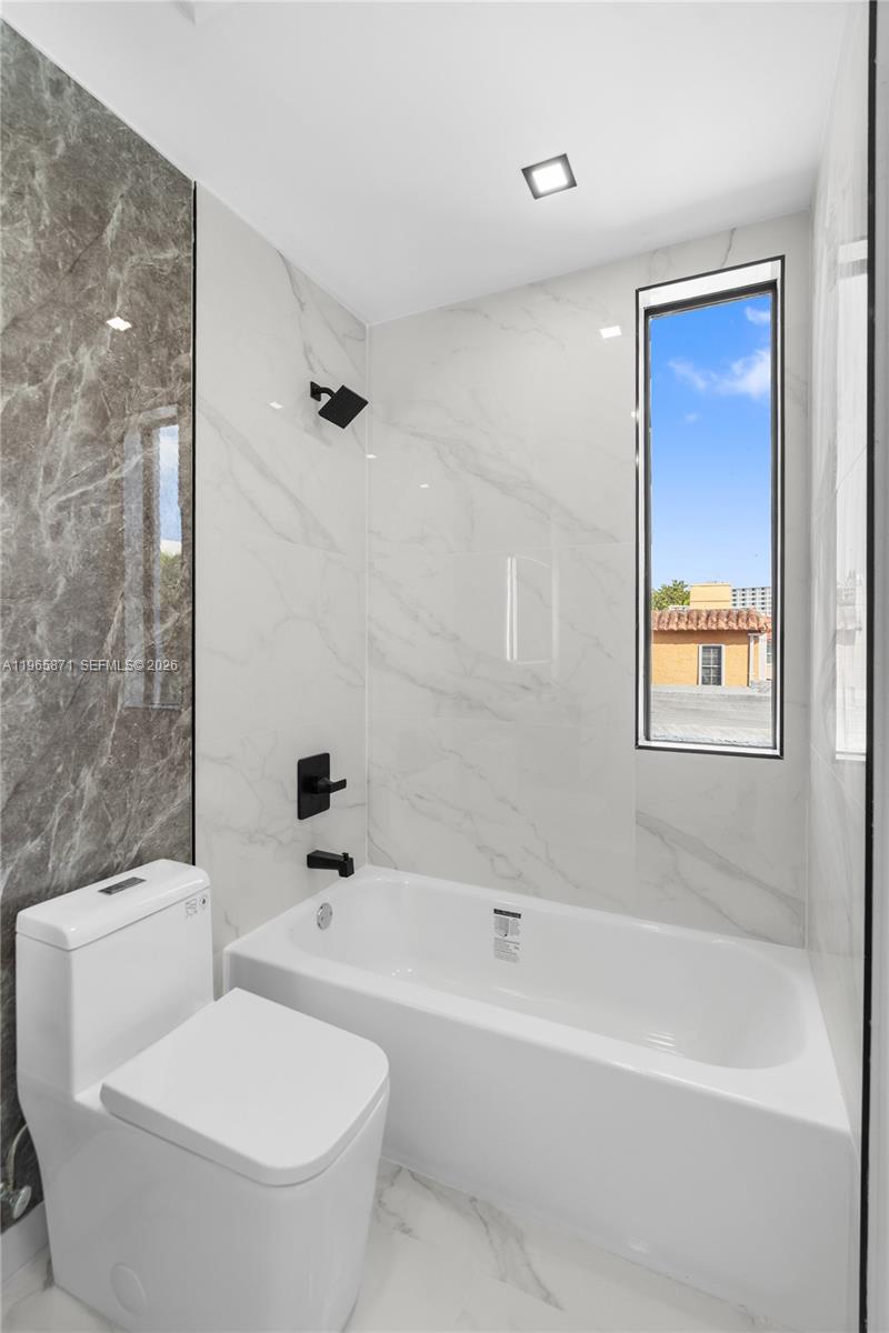 1644 Northwest 8th Terrace Miami, FL 33125 - Photo 41 of 60 a white toilet sitting next to a bath tub