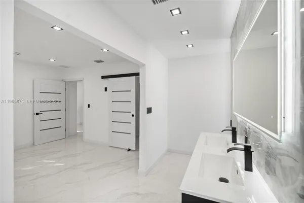 a view of a house with a small yard and plants