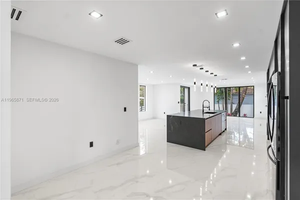 a white painted room with a potted plant