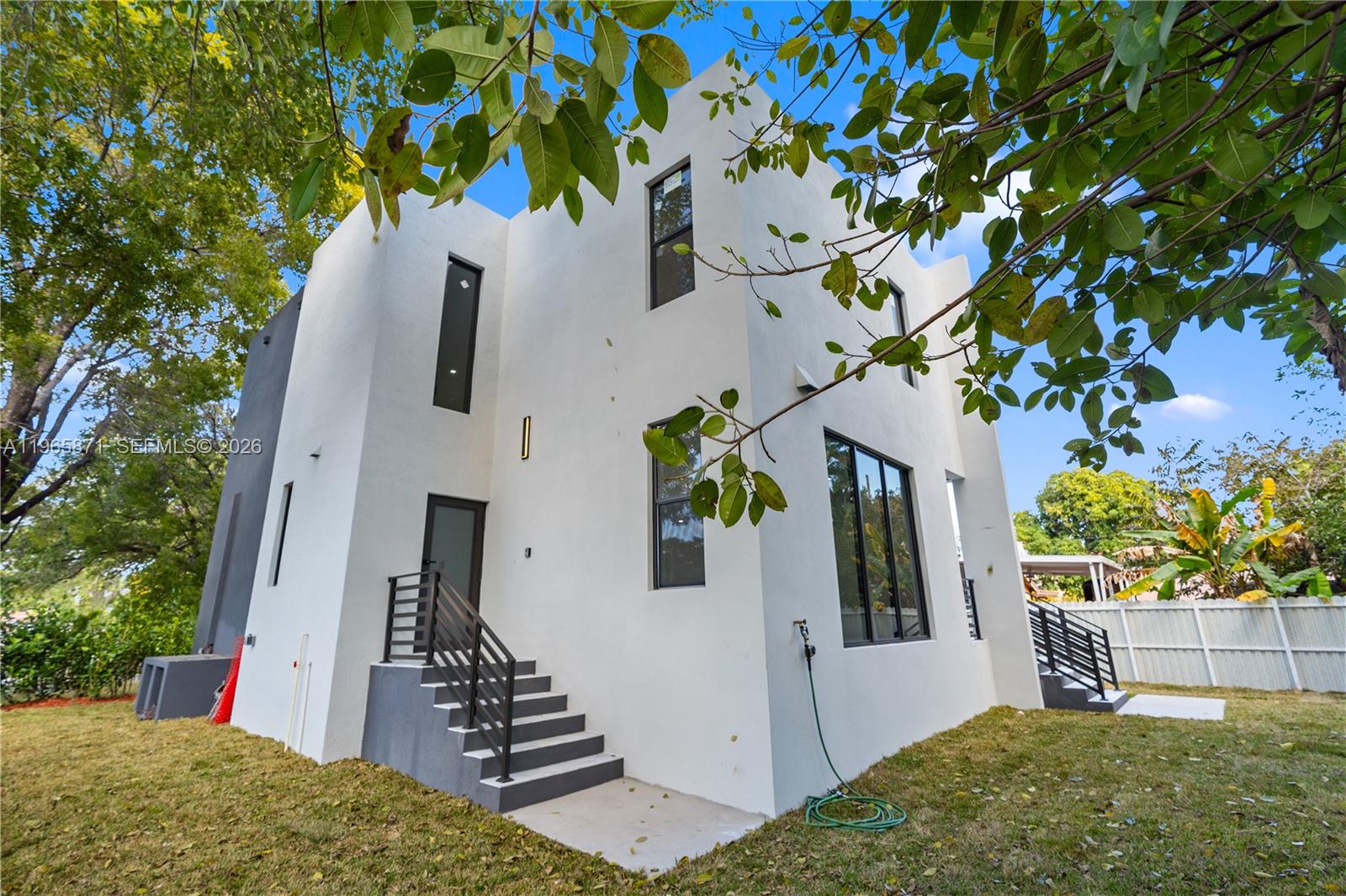 1644 Northwest 8th Terrace Miami, FL 33125 - Photo 55 of 60 a view of a house with a small yard and plants